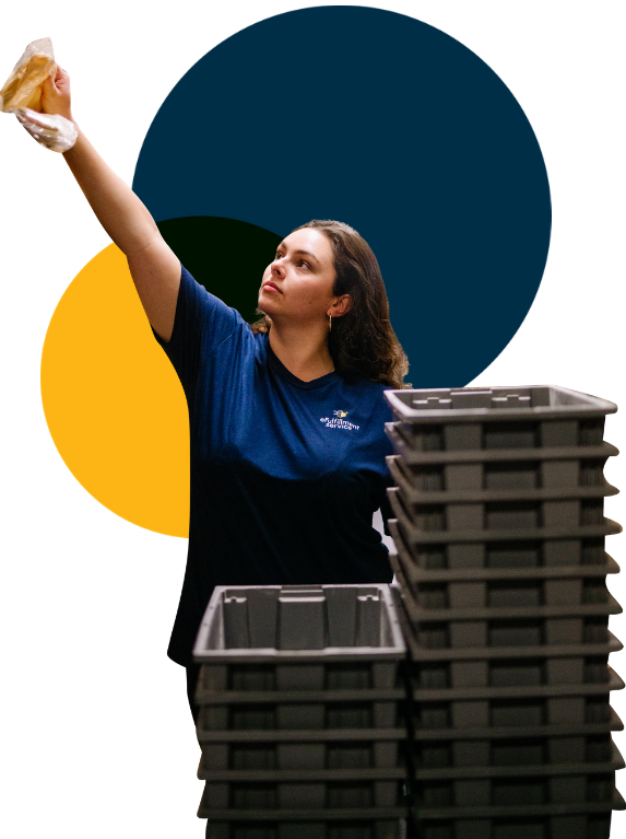 Lite PrepCenter Female Employee Reaching up With Stacked Bins