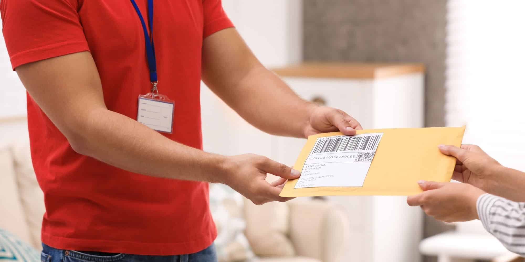 handing over a book packaged in a padded envelope